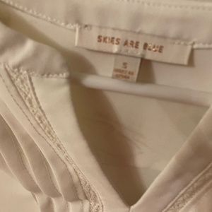 White 3/4 sleeve shirt with front detailing…I guess it’s polyester